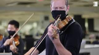 Concertmaster Jonathan Crow leads nine TSO musicians in performance at the Toronto Star newsroom