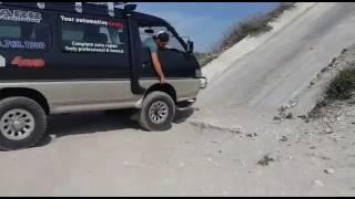 Mitsubishi Delica L300 climbing a steep cement grade