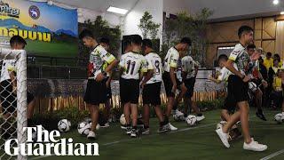 Rescued Thai boys kick footballs at beginning of press conference