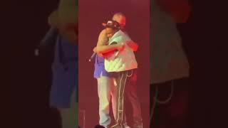 Post Malone & Roddy Ricch hugging on stage