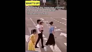 Heartwarming moment! Woman helps injured girl cross the road