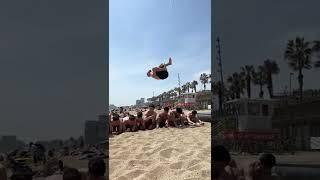 Professional Athlete Flips Over Group of People At Beach - 1272801