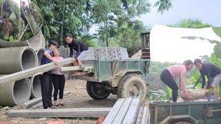 Ms. Dam helps Mr. Vang prepare materials to build a new house.