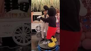 Freedom From Desire; Mickey Mouse Dancing on booth with a friend