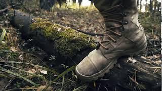 mens shoes in autumn a man tied a lacing on boots in the woods r
