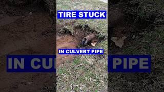 Tire Stuck Cleaning Culvert