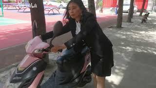 business woman kickstarting cranking scooter heel pedal pumping