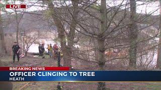 Officer clinging to tree in Licking County, rescue underway