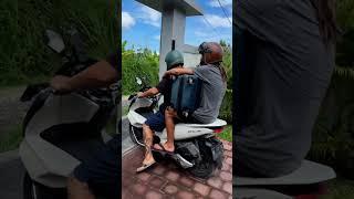 When in BALI, this how to carry your suitcase...