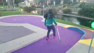 Samantha Tapia playing miniature golf with daddy.