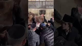 Viznitz Rebbe R Mendel greeting people in his way out from the Kosel