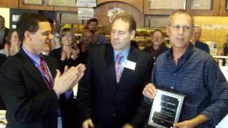 The August Group presents Randy Thompson and the Bagel Bin Cafe a plaque of appreciation