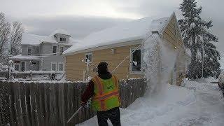 Snow Removal From The Roof Of A House Stopping Ice Dams (Time Lapse)