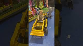 Trying the ride on toys at the toy shop