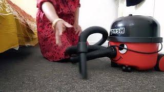 cleaning bed room with Numatic Henry vacuum cleaner,  UK lifestyle.