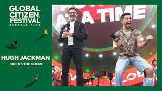 Host Hugh Jackman on stage with presenters | Global Citizen Festival NYC 2024