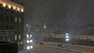 Snowfall and blizzard in Moscow in the bright spotlights