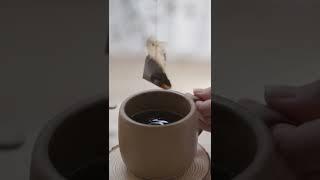 A Person Dipping a Tea Bag