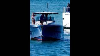 One fancy yacht watching another one anchor at the Haulover Inlet sandbar.