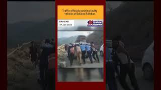 Traffic officials pushing faulty vehicle at Dalwas Ramban.