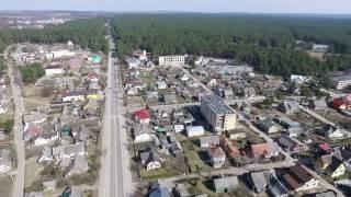 Flight Over Small Town Near Forest With Fast Rotation - cutestockfootage.com