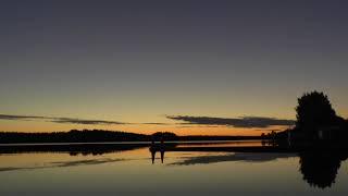 Dawn on the lake with an unexpected ending. Timelapse