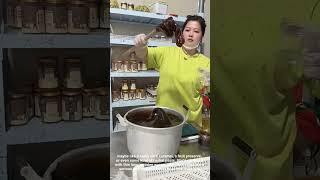 Lady Stirs Thick Gooey Sweet Traditional Treat in Big Pot