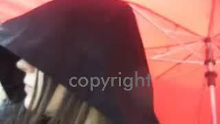 Gentle Rain Shower woman walking in the with boots galosh wellies