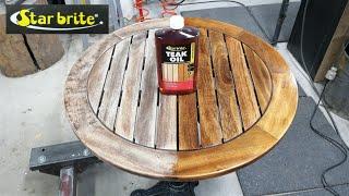 oiling a wooden table with Star brite teak oil