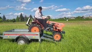 Loading Kubota B6001 compact tractor to car trailer for tranportation